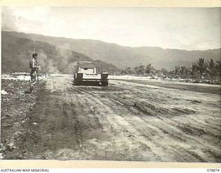 WUNUNG PLANTATION, NEW BRITAIN. 1945-01-29. A TANK TRANSPORTER BEING USED TO COMPACT THE SOIL DURING CONSTRUCTION OF A SMALL AIRSTRIP AT HEADQUARTERS, 5TH DIVISION