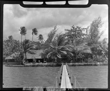 Tropique Hotel, Tahiti, showing huts, palm trees and small walk bridge leading out to the lagoon