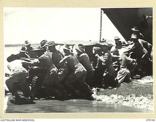 TSIMBA AREA, BOUGAINVILLE ISLAND. 1945-02-16. TROOPS OF THE 4TH FIELD REGIMENT, LANDING THE UNIT JEEPS AND TRUCKS ON THE BEACH AT PUTO