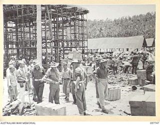 MUSCHU ISLAND, NEW GUINEA. 1945-10-10. MAJOR E.S. OWENS, ASSISTANT ADJUTANT AND QUARTERMASTER GENERAL, HEADQUARTERS 6 DIVISION, MAKING AN INSPECTION OF STORES FOLLOWING THE ARRIVAL OF APPROXIMATELY ..