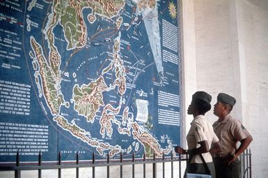 Marines from the PHOTO Section, Marine Corps Air Station, Kaneohe, view a map of World War II battles during a visit to the National Memorial Cemetery of the Pacific at Punch Bowl