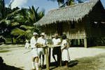 [Inspecting coffee], village home, Logea Island, 1957