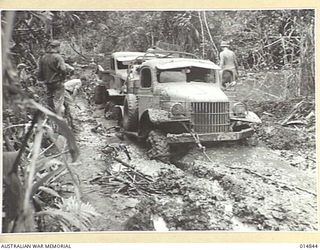 1943-05-17. NEW GUINEA. ARMY MAIL MUST GO THROUGH. LOOK AT THE ROADS IT GOES THROUGH. THIS PARTICULAR JEEP WAS BOGGED SEVEN SEPARATE TIMES ON THIS "ROAD". THE JEEP IS TOWED OUT. (NEGATIVE BY N. ..