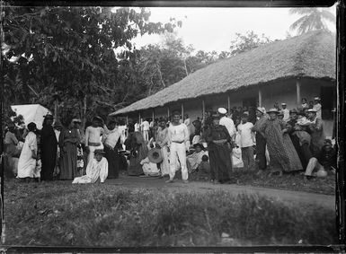 Crowd watching the hoisting of the Union Jack at Aitutaki, at the annexation of the Cook Islands by New Zealand