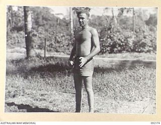 JACQUINOT BAY, NEW BRITAIN. 1945-05-18. PRIVATE J. KELLY TAKING A "BREATHER" AFTER A GAME OF BADMINTON AT HEADQUARTERS 5 DIVISION