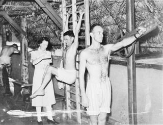 1943-04-01. PHYSIOTHERAPY DEPARTMENT. AT AN AUSTRALIAN GENERAL HOSPITAL IN NEW GUINEA WHICH HAS TAKEN OVER A SPECIALLY CONSTRUCTED NATIVE HUT TO CARRY OUT REHABILITATION TREATMENT - THE AIM OF ..