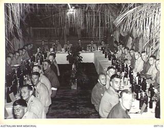 LAE AREA, NEW GUINEA. 1945-09-21. A FAREWELL DINNER HELD IN THE SERGEANTS' MESS, 2/7 ADVANCED WORKSHOP, TO MARK THE UNIT'S CHANGE-OVER WITH 2/1 ADVANCED WORKSHOP. THE COMMANDING OFFICERS OF BOTH ..