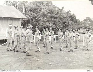 LAE, NEW GUINEA. 1944-09-21. VX244 MAJOR H.M. AUSTIN, ASSISTANT PROVOST MARSHAL, HEADQUARTERS, NEW GUINEA FORCE (1) INSPECTING THE DUTY SECTION OF THE NEW GUINEA FORCE PROVOST COMPANY. IDENTIFIED ..