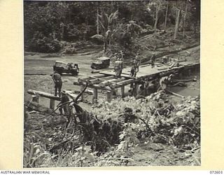 KILIGIA, NEW GUINEA. 1944-04-11. A NEW BRIDGE UNDER CONSTRUCTION ACROSS THE SOWI RIVER BY MEMBERS OF THE 8TH FIELD COMPANY, ROYAL AUSTRALIAN ENGINEERS