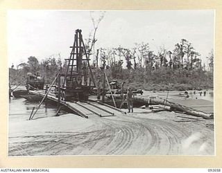 MINGA CREEK, WEWAK AREA, NEW GUINEA. 1945-05-30. A TEMPORARY PONTOON BRIDGE IN THE MINGA CREEK AREA, CONSTRUCTED BY 2/8 FIELD COMPANY ROYAL AUSTRALIAN ENGINEERS, UNDER COVER OF DARKNESS PRIOR TO ..