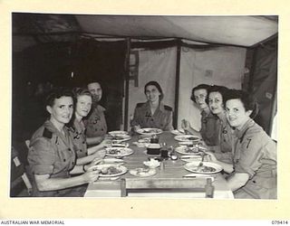 WUNUNG PLANTATION, JACQUINOT BAY, NEW BRITAIN. 1945-03-02. MEMBERS OF THE ARMY NURSING SERVICE AT LUNCH IN THE TEMPORARY MESS HUT AT THE 105TH CASUALTY CLEARING STATION. IDENTIFIED PERSONNEL ARE:- ..