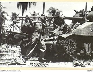 MADANG, NEW GUINEA. 1944-10-12. THE CLEANING OF A GUN DURING TANK TESTS CONDUCTED AT HQ 4 ARMOURED BRIGADE