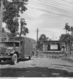 LAE, NEW GUINEA. 1944-09-08. THE COMBINED THEATRE CINEMA AT HEADQUARTERS, NEW GUINEA FORCE, SHOWING THE CINEMA UNIT OF THE 76TH AUSTRALIAN CINEMA TRUCK IN THE LEFT FOREGROUND