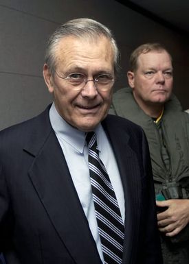 The Honorable Donald H. Rumsfeld (front), U.S. Secretary of Defense, and U.S. Air Force GEN. Dennis Larsen (back), Commander, 13th Air Force, listen to a SH-60 helicopter pre-flight safety briefing prior to taking an aerial tour of Guam, hosted and lead by U.S. Navy Rear Adm. Patrick Dunne, Commander, U.S. Naval Forces, Marianas, on Nov. 14, 2003. Secretary Rumsfeld is on his way to official meetings in both Japan and the Republic of Korea. (DoD photo by PETTY Officer 2nd Class Nathanael T. Miller) (Released)