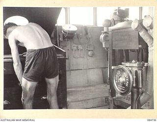 MADANG, NEW GUINEA. 1944-11-06. SUB- LIEUTENANT J K SULLIVAN, GUNNERY OFFICER, AT THE WHEELHOUSE ABOARD HMAS STAWELL