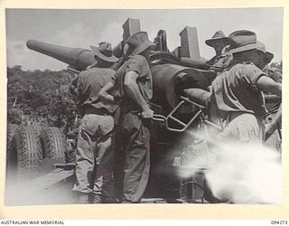 BOIKEN, NEW GUINEA, 1945-07-18. MEMBERS OF 2/2 FIELD REGIMENT, ROYAL AUSTRALIAN ARTILLERY, LOADING THE 155MM M1 "LONG TOM" BEFORE FIRING ONTO THE JAPANESE POSITIONS 14,600 YARDS AWAY. THE SHELL ..
