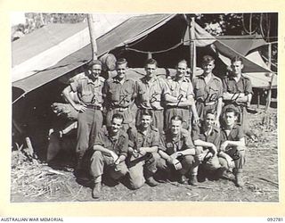 SORAKEN, BOUGAINVILLE. 1945-06-05. THE STAFF OF F TROOP COMMAND POST, 4 FIELD REGIMENT, OUTSIDE THEIR LOG COMMAND POST. (FOR IDENTIFICATION OF 11 NAMED PERSONNEL REFER TO PROVISIONAL CAPTION OR ..