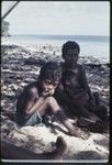 Woman and children on a beach near Kaibola village