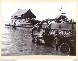 MALAGUNA, NEW BRITAIN. 1945-09-20. TROOPS OF 11 INFANTRY BATTALION, 13 INFANTRY BRIGADE, FILLING A JEEP TRAILER WITH SEA WATER. THIS WATER IS SPRINKLED ON ROADS TO LAY THE DUST. THE THICK PUMICE ..