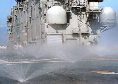 A view onboard the flight deck of the US Navy (USN) Tarawa Class: Amphibious Assault ship, USS SAIPAN (LHA 2) as the ship conducts a test its Counter Measure Wash Down System (CMWDS), while underway in the Atlantic Ocean taking part in the North Atlantic Treaty Organizations (NATO) Standing Naval Force Atlantic (SNFL) 2004 exercises. SNFL is a permanent peacetime multinational naval squadron composed of destroyers and frigates from the navies of various NATO nations