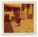 Betty Takamori sitting on stairs in front of house