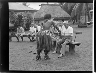 One of the performers pouring [kava?] into a bowl for a guest while the others look on, meke, Lautoka, Fiji