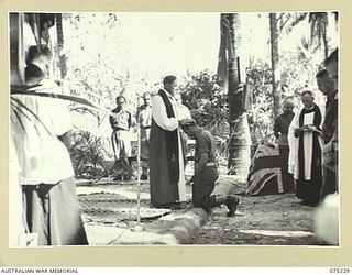 NORTH ALEXISHAFEN, NEW GUINEA. 1944-08-10. VX20306 CHAPLAIN GENERAL C.L. RILEY, CBE, VD BISHOP OF BENDIGO, VICTORIA, HEADQUARTERS, NEW GUINEA FORCE, PERFORMING THE LAYING ON OF HANDS DURING THE ..