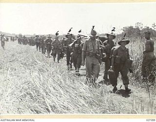 WANIGELA, NEW GUINEA. 1942-10. MEMBERS OF THE 2/6TH AUSTRALIAN INDEPENDENT COMPANY WHO HAVE JUST ARRIVED BY PLANE FROM PORT MORESBY CAME OUT OF THE PLANES READY EQUIPPED AND ARE SEEN HERE HEADING ..