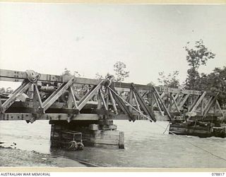 DANMAP RIVER, NEW GUINEA. 1945-01-26. TROOPS OF THE 2/14TH FIELD COMPANY WORKING ON THE CONSTRUCTION OF A PERMANENT 300 FOOT GIRDER BRIDGE ACROSS A RIVER