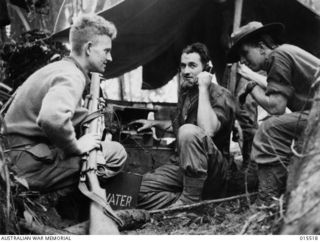 1943-08-11. NEW GUINEA. MOUNT TAMBU FIGHTING. CPL. HARRY CRANSTON, OF NORTHCOTE, VIC., AND SIG. ROGER HAGAN, OF YARRAVILLE, VIC., AT AN ADVANCED SIGNAL POST IN THE MOUNTAIN-SIDE OF MOUNT TAMBU. ..