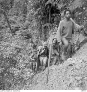 NEW GUINEA, 1943-07-20. A NARROW PART OF THE TRACK BETWEEN NEIL'S CREEK AND GUADAGASAL RIDGE. SHOWN ARE:- LIEUTENANT F. BOWERS, UNITED STATES AND ALLIED TRANSLATION AND INTELLIGENCE SERVICE; ..