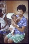 Woman holds young infant