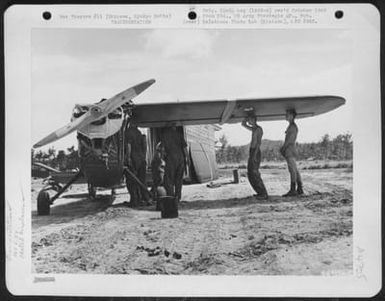 Men Attach A Wing To One Of The Vultee L-5 Of The 163Rd Liaison Squadron Attached To The 10Th Army. The Plane Has Just Been Uncrated At Cub Field No. 7 On Okinawa, Ryukyu Retto, After Shipment From Hawaii. 1945. (U.S. Air Force Number 64717AC)