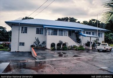 Vanuatu - White building with blue roof, overcast sky