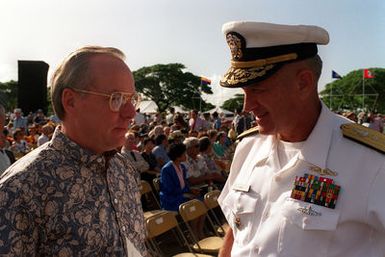 Secretary of the Navy H. Lawrence Garrett III speaks with RADM Larry G. Vogt, director for plans and policy, Commander in CHIEF, U.S. Pacific Fleet, during Survivor's Day ceremonies at the USS ARIZONA Memorial Visitors Center. The event honors the sailors and Marines of the battleships that were sunk or damaged in the Dec. 7, 1941, attack on Pearl Harbor