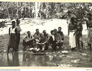 KILIGIA, NEW GUINEA, 1944-03-15. MEMBERS OF THE 3RD ARMOURED DIVISION CONCERT PARTY REHEARSING LINES ON THE BANKS OF THE CREEK AT WHICH THEY ARE CAMPED. TROOPER BAILEY IS AMUSING AUSTRALIAN NEW ..
