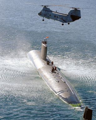 Crewmembers aboard a US Navy (USN) LOS ANGELES CLASS Attack Submarine prepare to practice Emergency Personnel Transfer Hoist Training with a USN CH-46 Sea Knight Helicopter, from Helicopter Combat Support Squadron 5 (HC 5), in Apra Harbor, Guam