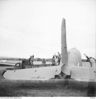 DREGER HARBOUR, NEW GUINEA. 1944-01. WALKING PATIENTS FROM THE STRIP A.D.S (AIRSTRIP ADVANCED DRESSING STATION) OPERATED BY THE 10TH FIELD AMBULANCE, BEING LOADED INTO AN AIRCRAFT FOR TRANSPORT ..