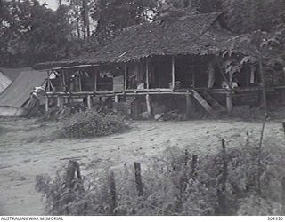 LANGEMAK, NEW GUINEA. 1944-05. THE NAVAL STAFF OFFICE, A WOODEN THATCHED BUILDING. (NAVAL HISTORICAL COLLECTION)