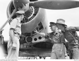 TOROKINA, BOUGAINVILLE ISLAND, SOLOMON ISLANDS. 1945-01-19. 32294 FLYING OFFICER F. T. BINNS OF SYDNEY, NSW (CENTRE), ENGINEER OFFICER OF NO. 5 (ARMY CO-OPERATION) SQUADRON RAAF BASED AT PIVA ..