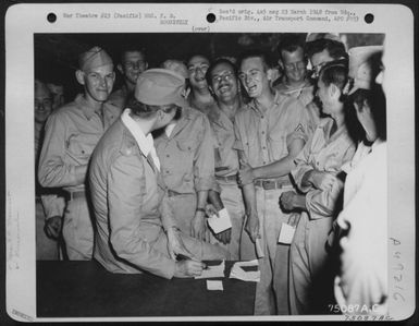 During Her Tour Of The Pacific Bases Mrs. F. D. Roosevelt Jokes With Enlisted Men At Guadalcanal As She Give Autographs. Solomon Islands, 1943. (U.S. Air Force Number 75087AC)