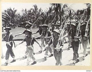 WUNUNG, JACQUINOT BAY, NEW BRITAIN, 1945-08-28. A FULL PARADE OF 37/52 INFANTRY BATTALION AND 29/46 INFANTRY BATTALION, BOTH OF 4 BRIGADE, WAS HELD ON WUNUNG AIRSTRIP. THIS PARADE WAS TO PREPARE ..