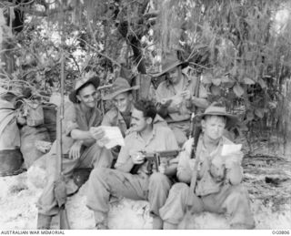 LOS NEGROS ISLAND, ADMIRALTY ISLANDS. 1944-03-18. JAPANESE PROPAGANDA LEAFLETS FOUND ON THE BEACH CAUSE SOME AMUSEMENT AMONG THESE RAAF AIRMEN. LEFT TO RIGHT: LEADING AIRCRAFTMAN (LAC) T. LEVINGS, ..