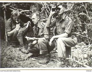 SALAMAUA, NEW GUINEA, 1943-08-09. LEFT TO RIGHT ARE NX14782 GUNNER H. E. NEWBY, NX50638 BOMBARDIER G. A. TURNER AND NX34977 LIEUTENANT C. R. LORD, ALL OF THE 2/6TH AUSTRALIAN FIELD REGIMENT, ..