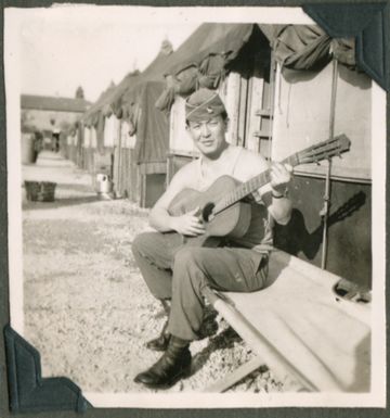 Soldier playing a guitar