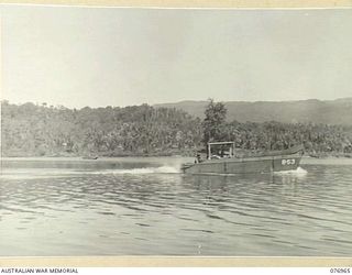 JACQUINOT BAY, NEW BRITAIN. 1944-11-16. UNITED STATES ARMY BARGES PASSING THE AREA IN THE SUNUNG PLANTATION WHICH MEMBERS OF THE 14/32ND INFANTRY BATTALION HAVE CLEARED FOR THEIR NEW CAMP SITE