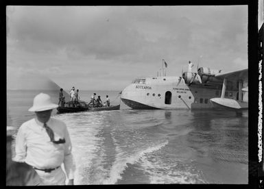 Tasman Empire Airways Ltd Short Empire flying boat 'Aotearoa' ZK-AMA, with unidentified men in boats alongside, Suva, Fiji