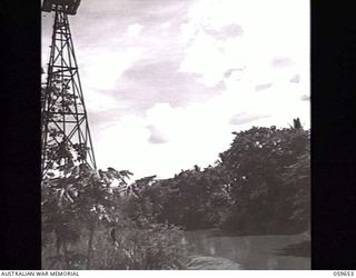 BOMANA, NEW GUINEA. 1943-11-08. THE LALOKI RIVER NEAR THE BOMANA PUMPING STATION. NOTE THE WINDMILL STAND IN THE LEFT FOREGROUND