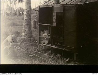 Lae, New guinea. 1944-06-18. A member of 17 Technical Maintenance Unit working on an incinerator still under construction using material salvaged from a Japanese wreck. It will dispose of food ..