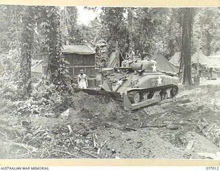 BOUGAINVILLE ISLAND, 1944-11-13. A GENERAL SHERMAN M4A1 MEDIUM TANK OF THE 754TH UNITED STATES TANK BATTALION FITTED WITH A M1 DOZER BLADE FOR CLEARING TRACKS THROUGH THE JUNGLE UNDER ENEMY FIRE ..